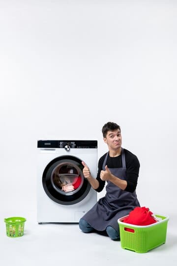 Picture of a guy giving thumbs up to the camera in front of a clean washing machine