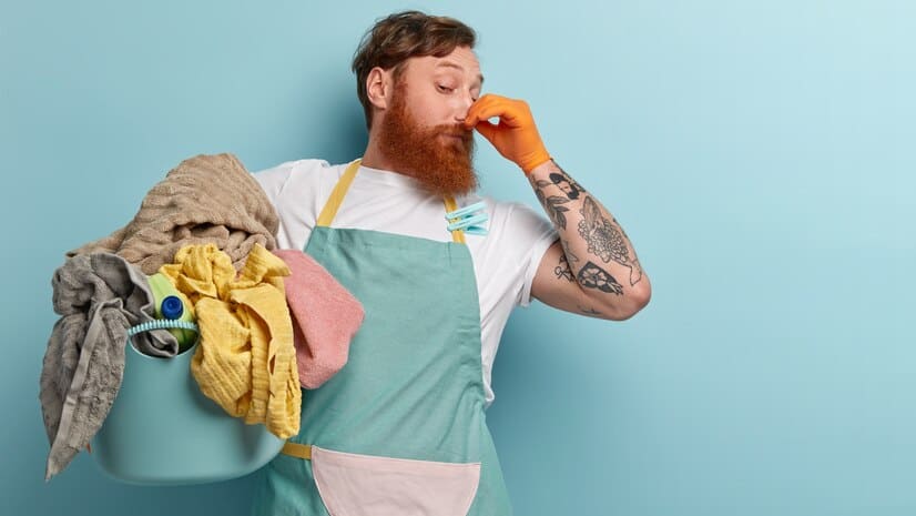 Picture of a guy holding dirty clothes